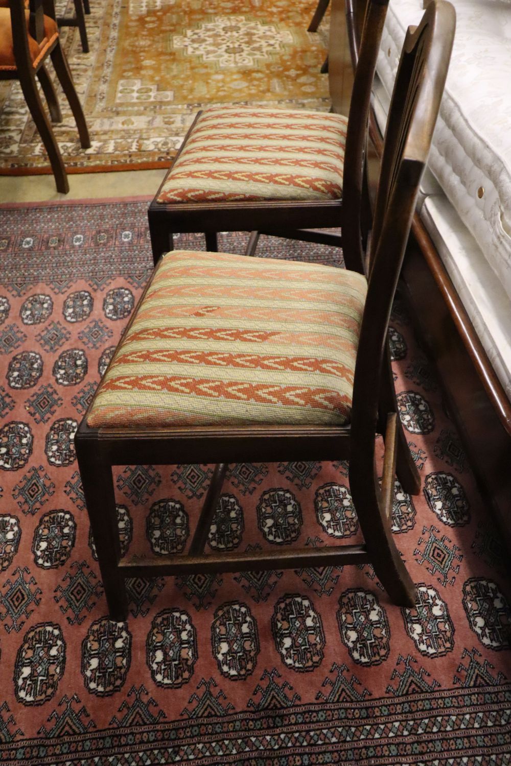 A set of four Hepplewhite style dining chairs (3 single, 1 arm) and four Edwardian dining chairs